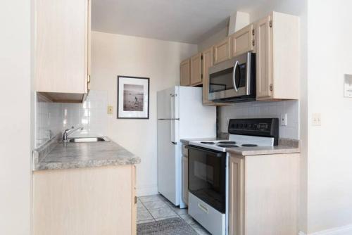 a kitchen with white appliances and a white refrigerator at Fabulous 2bed 2bath apartment downtown Boston in Boston