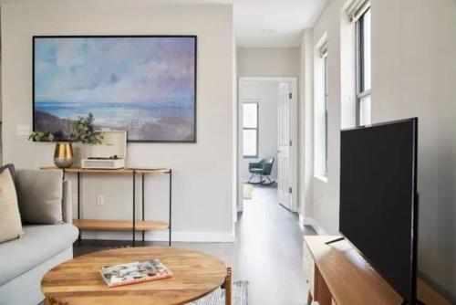 a living room with a couch and a table at New and Lovely 1br in FIDI District with Keyless Entry in Boston