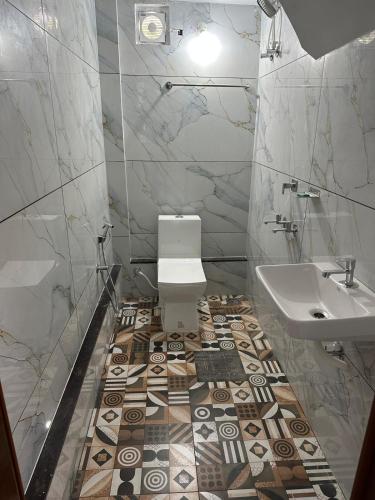 a bathroom with a toilet and a sink at Radhakrishna Residency in Kottayam