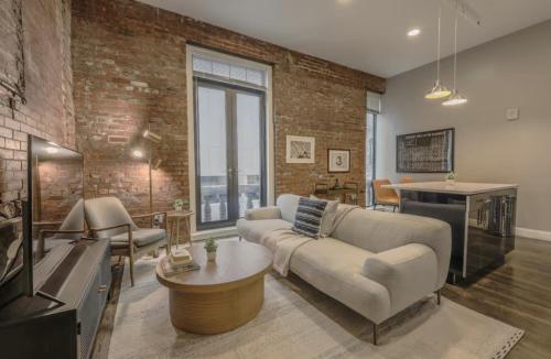 a living room with a couch and a table at Downtown Designer Home Keyless Washer and Dryer in Boston