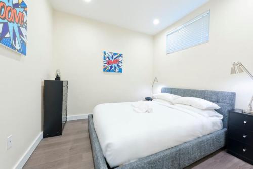 a bedroom with a large white bed and a window at Simple 1br Financial District Keyless Entry in Boston