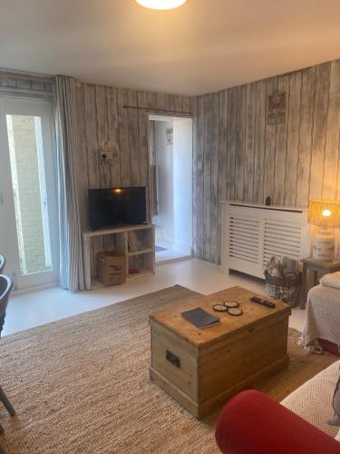 a living room with a tv and a coffee table at Isle 2-Bed Retreat- Sleeps 4 Garden & Games Room in Cowes