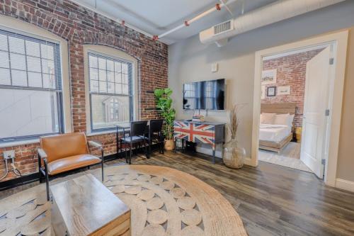 a living room with a brick wall at Pet Friendly 3 Bed 2 Bath steps to Beacon Hill in Boston