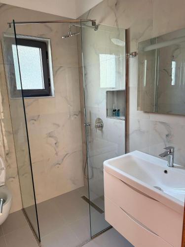a bathroom with a shower and a sink at Vila Bilali in Ksamil