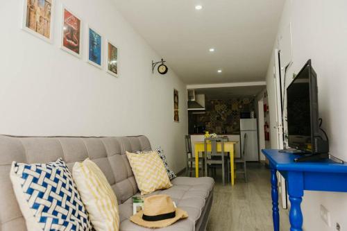 a living room with a couch and a blue table at Dandy's Blue Apartments in Setúbal