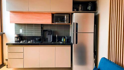 a kitchen with a stainless steel refrigerator at Flat FM20 Cabo Branco Stilo - By Almare in João Pessoa