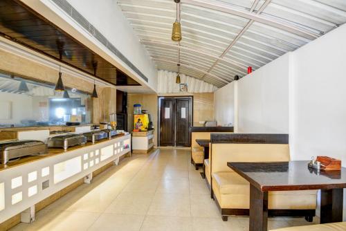a large kitchen with a table and some counters at Hotel Chanchal Deluxe - New Delhi Train Station in New Delhi