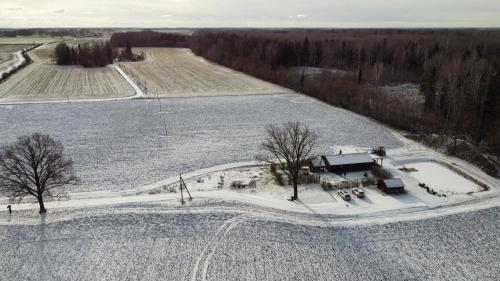 an aerial view of a farm in the snow at Atpūtas namiņš Skudriņas in Sesava