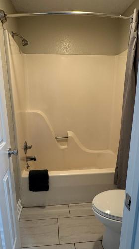 a bathroom with a tub and a toilet at Gators Inn on the Bayou in Larose