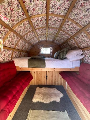 a bedroom in a yurt with a bed and a couch at Alnmouth Glamping in Alnmouth