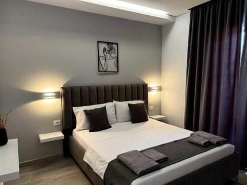 a bedroom with a large bed in a room at Apartments Klajdi in Sarandë