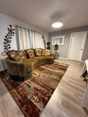 a living room with a couch and a rug at Casa De Colores - Airport - Fiesta Tx - The Pearl in San Antonio
