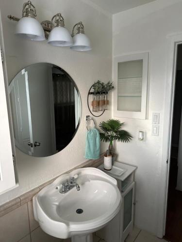 a bathroom with a sink and a mirror at Casa De Colores - Airport - Fiesta Tx - The Pearl in San Antonio