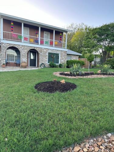 a house with a large yard in front of it at Casa De Colores - Airport - Fiesta Tx - The Pearl in San Antonio
