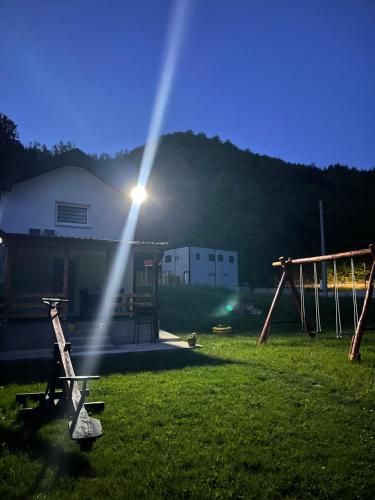 a light shining on a field with a playground at Apartman Elma in Jajce