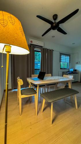 a living room with a table and a ceiling fan at Casa Azure Shah Alam in Shah Alam