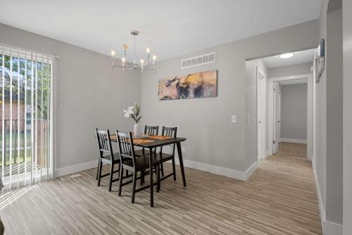 a dining room with a table and chairs at Serene & Modern Haven for Relaxation in Rochester Hills
