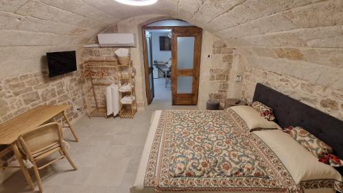 a bedroom with a large bed in a stone wall at Epoca B&B in Bitetto