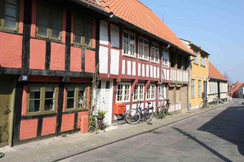 a red and white building with bikes parked in front of it at Severin Kursuscenter og Konferencehotel in Middelfart