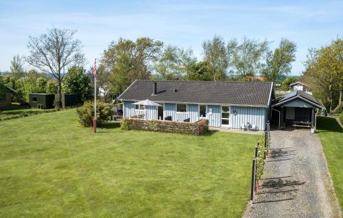 a house with a large yard in front of it at Holiday Home Sommerstedvej Denm in Vinderup