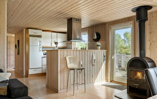 a kitchen and living room with a stove at Holiday Home Sommerstedvej Denm in Vinderup