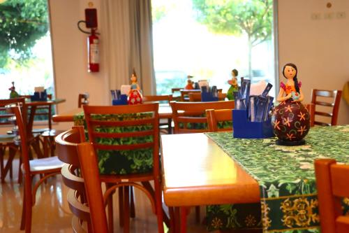 a restaurant with a doll sitting on a table at Reserve Hotel in Surubim