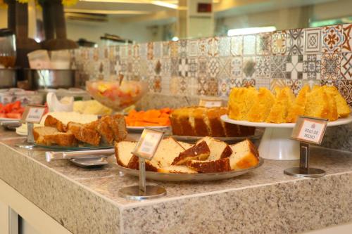 a buffet line with different types of bread and pastries at Reserve Hotel in Surubim