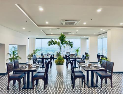 a restaurant with tables and chairs with a view at The Glance inn Udaipur by NAINA STAYCATION - Rooftop swimming pool ! prime location ! most awarded ! big parking ! in Udaipur
