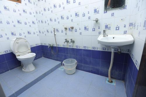 a blue and white bathroom with a toilet and sink at Happyhomes Porur -Near RMZ Software Park-Commerzone-DLF IT SEZ Park -L&T in Chennai
