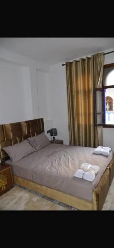 a bedroom with a large bed with two towels on it at Apartamentos nuevos in Chefchaouen