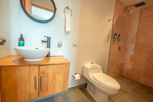a bathroom with a sink and a toilet and a shower at La Martina Boutique Hotel in Medellín