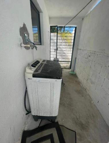 a room with a heater in the corner of a room at La Casa del Arbol in Chelem