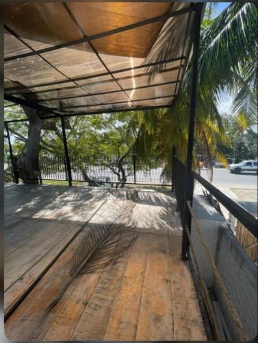 a wooden deck with awning on top of a building at La Casa del Arbol in Chelem