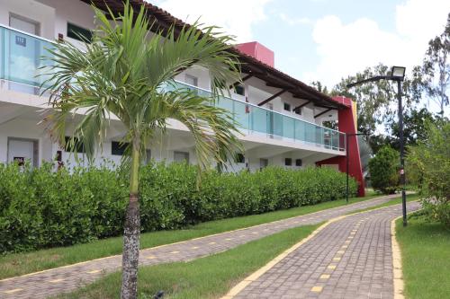 a palm tree in front of a building at Reserve Hotel in Surubim