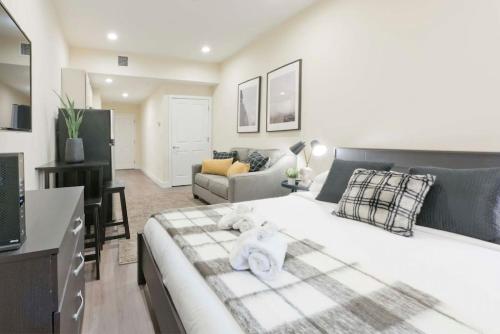 a bedroom with a large white bed and a living room at Centrally Located Loft Walk Anywhere Pets OK in Boston
