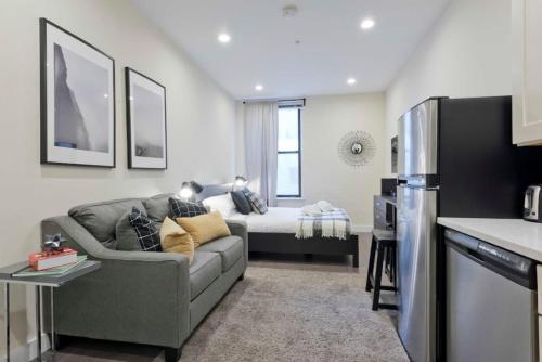 a living room with a couch and a bed at Centrally Located Loft Walk Anywhere Pets OK in Boston
