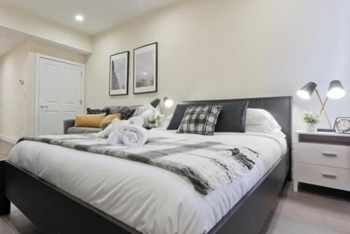 a bedroom with a large bed with a black and white comforter at Centrally Located Loft Walk Anywhere Pets OK in Boston
