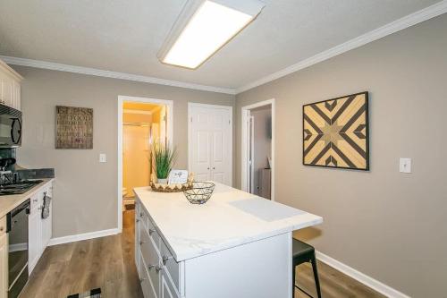 a kitchen with a white counter top in a room at Downtown Condo - Walk to Mercedes Stadium and Coca in Atlanta