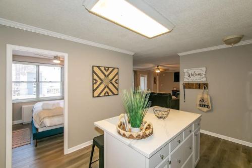a room with a white dresser with a plant on it at Downtown Condo - Walk to Mercedes Stadium and Coca in Atlanta