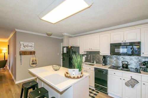 a kitchen with white cabinets and a counter top at Downtown Condo - Walk to Mercedes Stadium and Coca in Atlanta