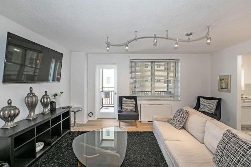a living room with a couch and a table at Downtown Condo Walk to GWCC and Coca-Cola in Atlanta