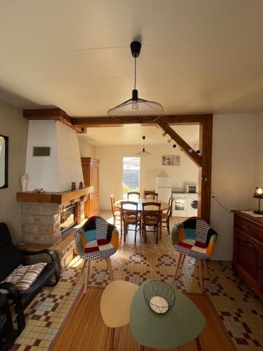 un salon avec une table et des chaises et une cuisine dans l'établissement Maison 3 chambres proximité commerce et plage, à L'Aiguillon-la-Presqu'île