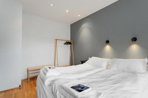 a bedroom with a white bed with a book on it at Reykjavík Central Apartments in Reykjavík