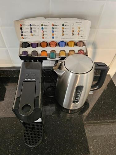 a coffee maker and a blender and a box of donuts at Family Stay Ourzazate - Deluxe Appartments in Ouarzazate