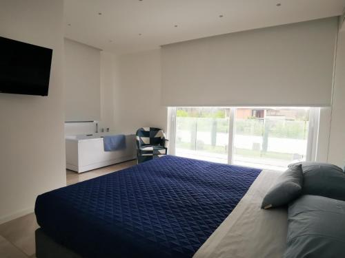 a bedroom with a bed and a large window at Ohahsi in Nola