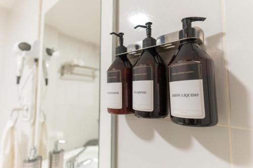 a group of bottles of wine hanging on a wall at Patagonia suites Bariloche in San Carlos de Bariloche