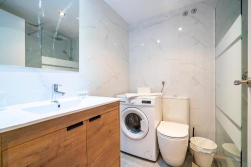 a bathroom with a washing machine and a sink at The Urban Studio Madrid in Madrid