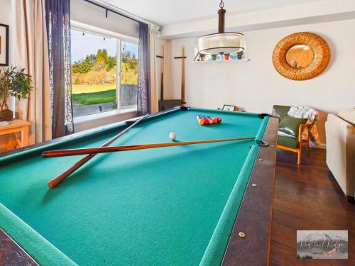 a pool table in a living room with a pool ball at 2 spaces More Space with 2 units at same location PNW Retreat in Philomath