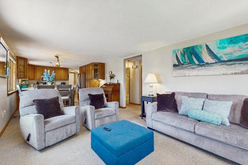 a living room with two couches and a kitchen at Wiggly Bridge Landing in York Harbor