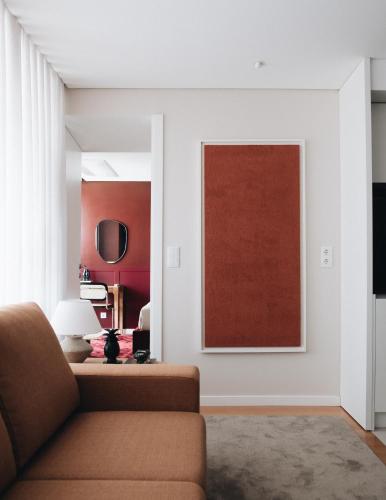 a living room with a couch and a painting on the wall at Flair Living in Vila Nova de Gaia